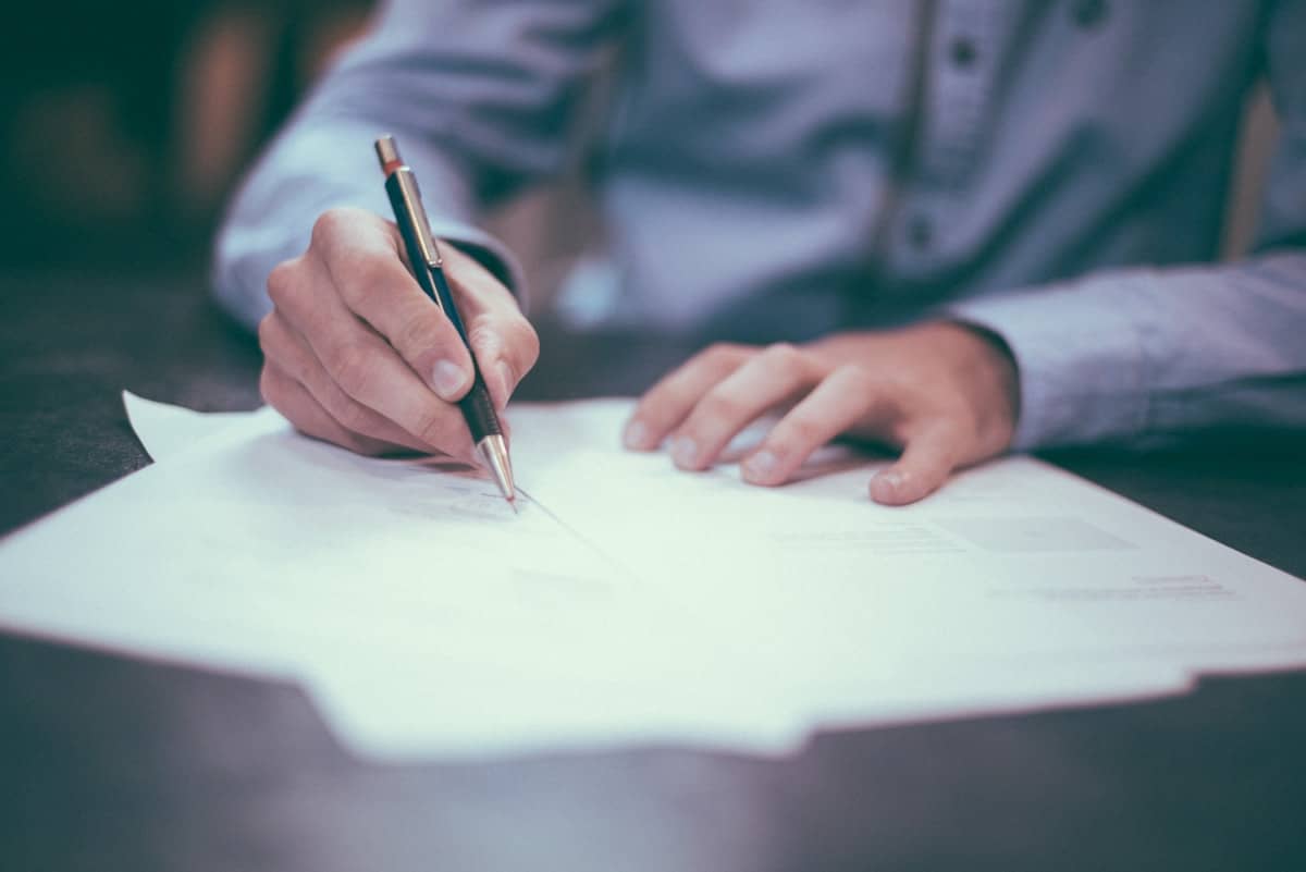 Auditor reviewing and signing documents